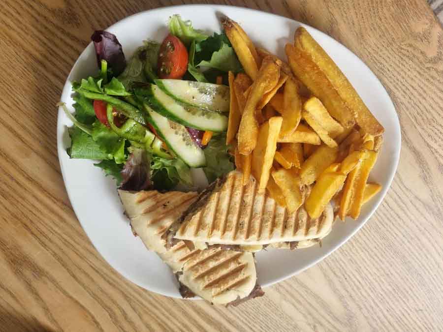Philly Beef Panini served with side salad and chips.
