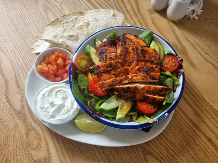Mexican Chicken Salad served with a tortilla and guacamole, sour cream and salsa