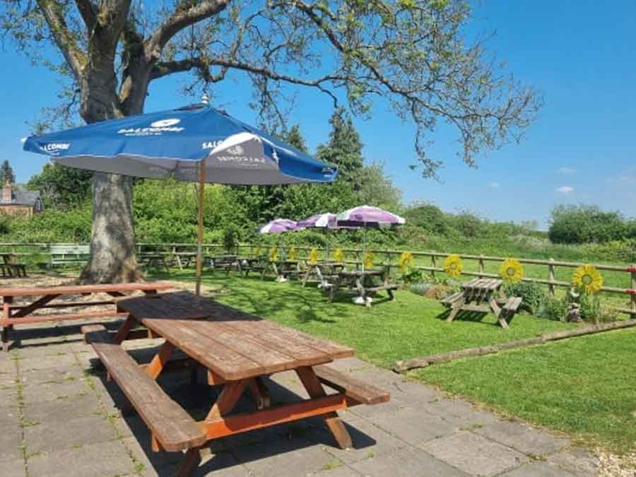 The beer garden at the Old Ox Inn Shillingstone Blandford Forum Dorset perfect for a drink, a meal or both in the sunshine